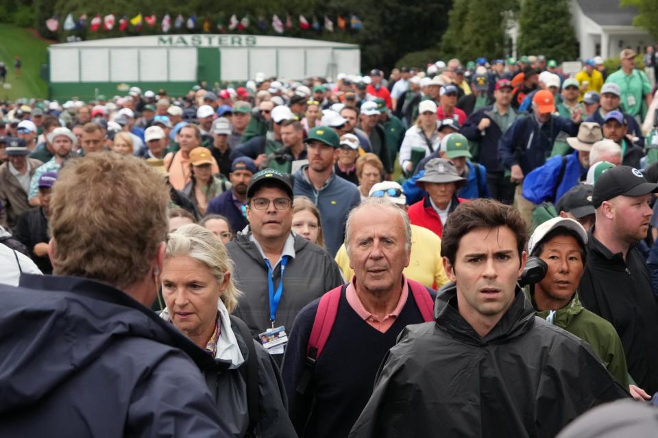 Apr 11, 2024; Augusta, Georgia, USA; Patrons make their way to the course after a delayed opening before the first round of the Masters Tournament. Mandatory Credit: Kyle Terada-USA TODAY Sports