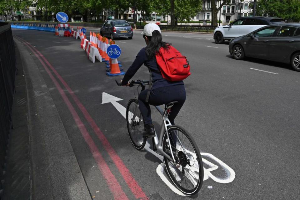 A cyclist makes use of a new expanded cycle lane on Park Lane in London.