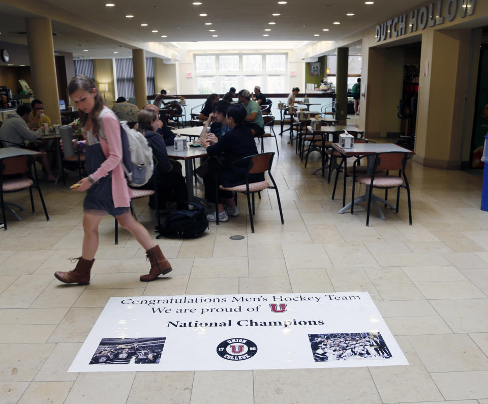 A sign congratulating the Union College men's hockey team is displayed on the floor of the Reamer Campus Center at Union on Monday, April 14, 2014, in Schenectady, N.Y. Tiny Union, enrollment 2,200, defeated Minnesota, enrollment 48,000, Saturday for its first NCAA hockey title. (AP Photo/Mike Groll)