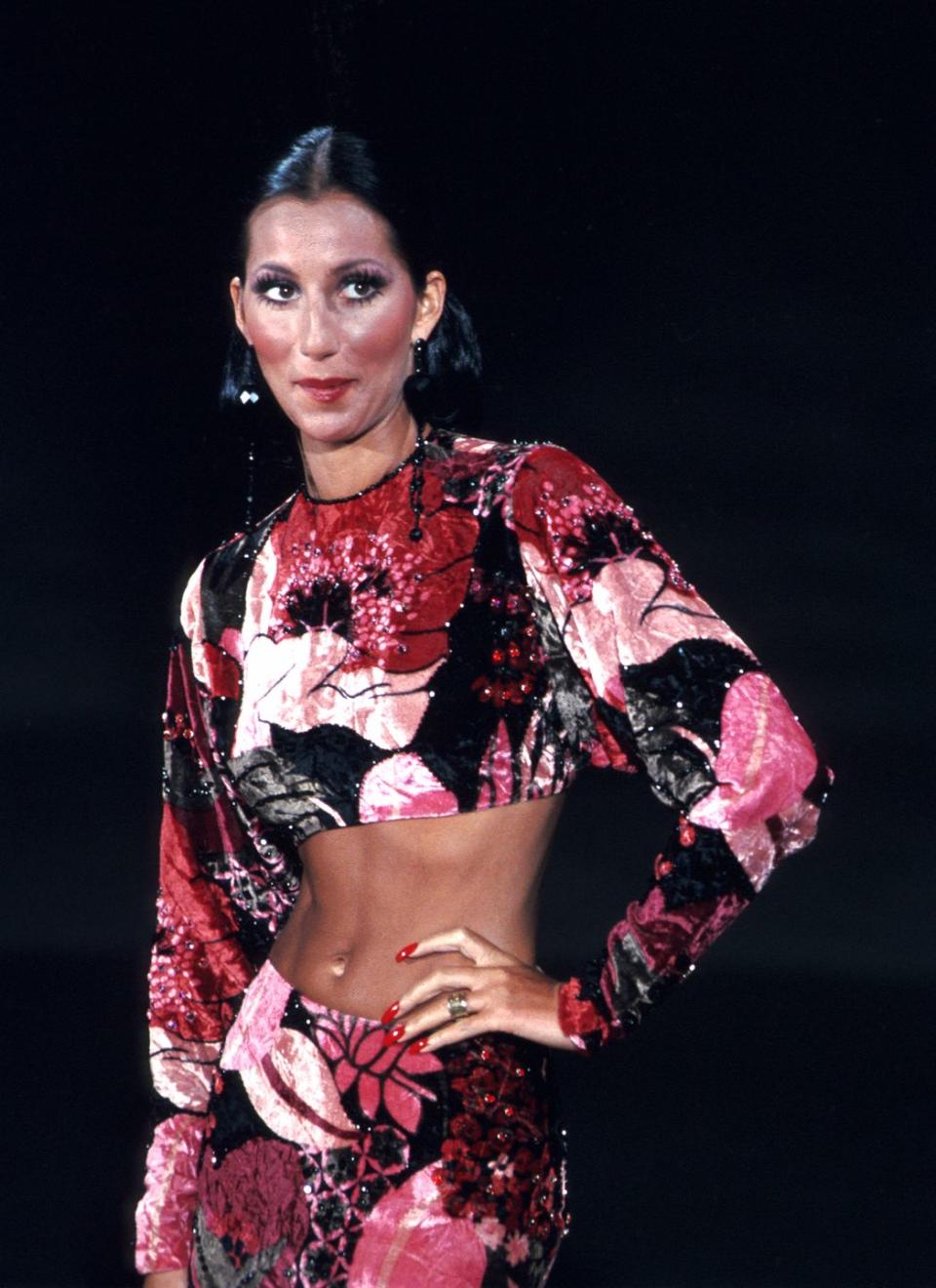 <p>Wearing a floral two-piece outfit and drop earrings while performing. </p>