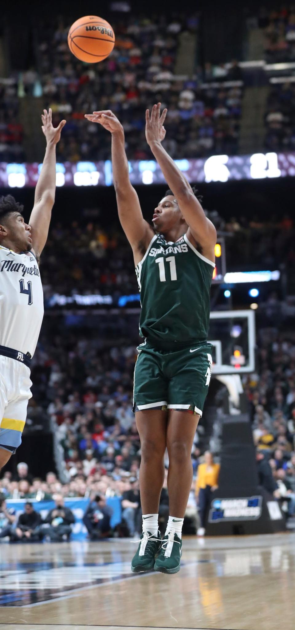 Michigan State Spartans guard A.J. Hoggard scores against Marquette Golden Eagles guard Stevie Mitchell during the first half in the second round of the NCAA tournament Sunday, March 19, 2023 in Columbus, Ohio.