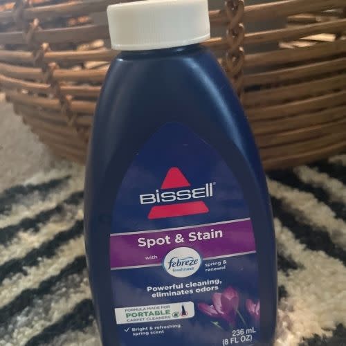 Bissell carpet cleanng solution in a navy bottle