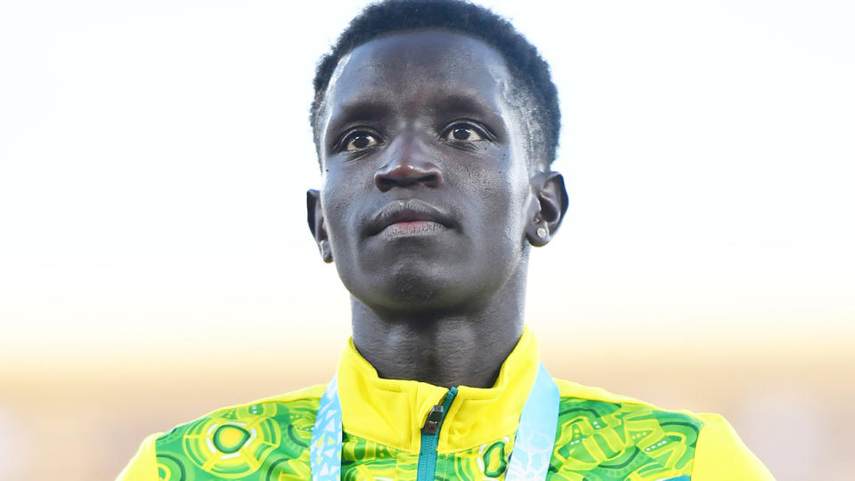 Peter Bol stands on the podium at the 2022 Commonwealth Games.