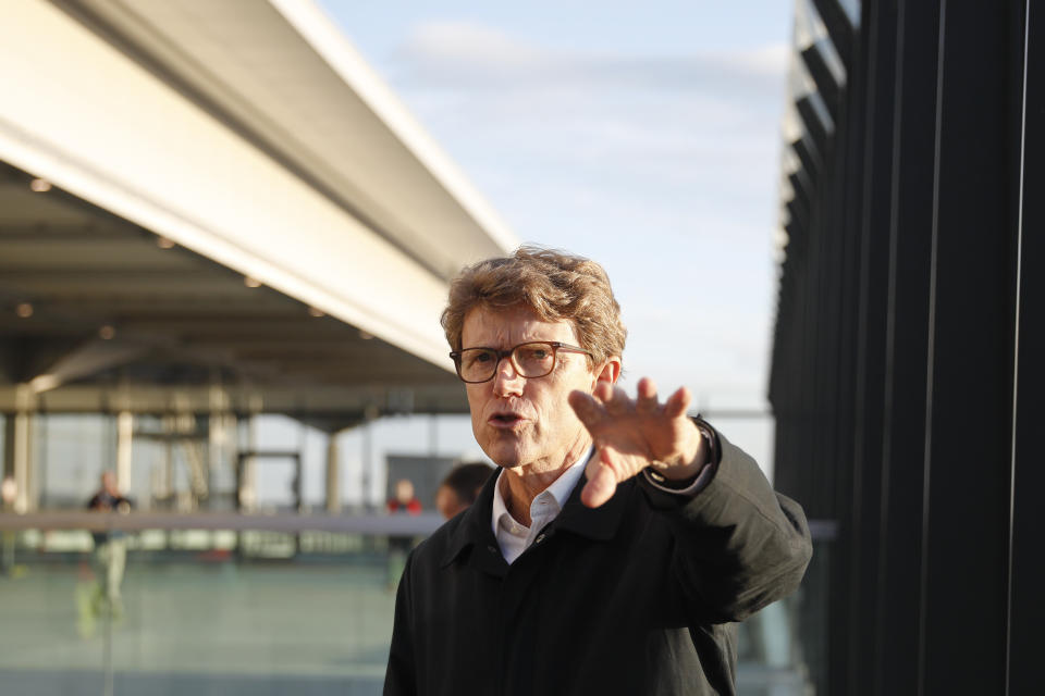 Luetke Daldrup, CEO of the new Berlin-Brandenburg-Airport 'Willy Brandt' speaks to media at the visitor terrace of the airport's Terminal 1, near Berlin in Schoenefeld, Germany, Tuesday, Oct. 27, 2020. After years of delays and massive cost overruns the opening of the German capital's new airport is scheduled for Saturday Oct. 31.(AP Photo/Markus Schreiber)