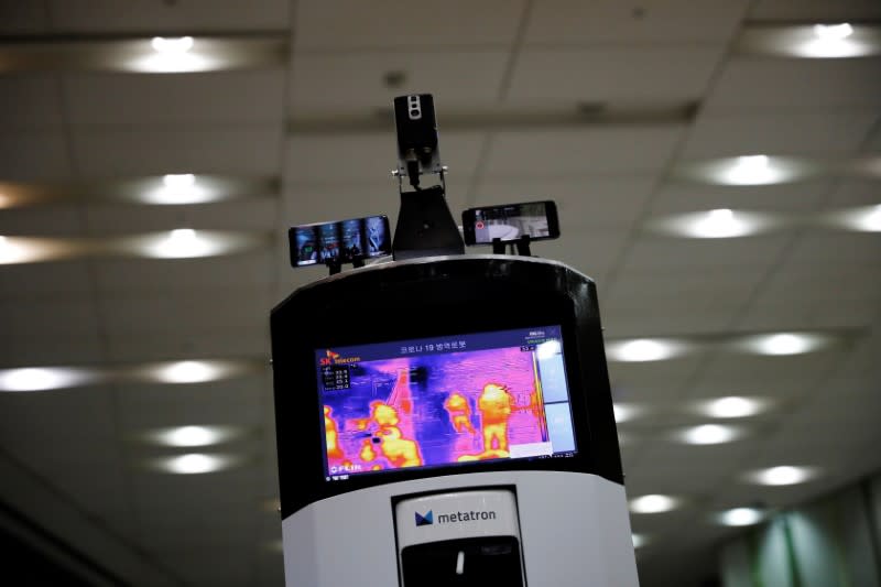 A self-driving robot checks a body temperature during its demonstration at the headquarter of SK Telecom in Seoul