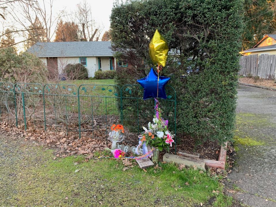 An impromptu memorial stands outside the Keizer home where a woman died after an allegedly drunk driver drove his car into the side of the house.