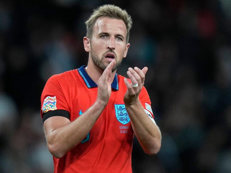 Harry Kane claps during an England soccer match.