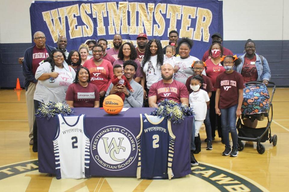 MJ Collins, middle, poses for a picture with the rest of his family after signing to play basketball at Virginia Tech.