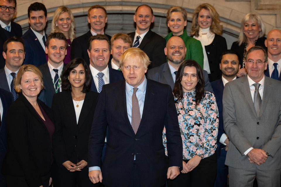 Prime Minister Boris Johnson alongside the newly elected Conservative MPs at the Houses of Parliament in Westminster, London, after the party gained an 80-seat majority in the General Election.