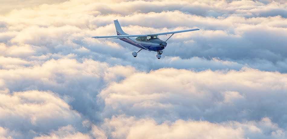 Small single engine airplane flying in the gorgeous sunset sky