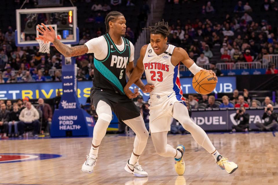 Pistons guard Jaden Ivey moves the ball up court as Trail Blazers guard Cam Reddish defends during the first half on Monday, March 6, 2023, at Little Caesars Arena.