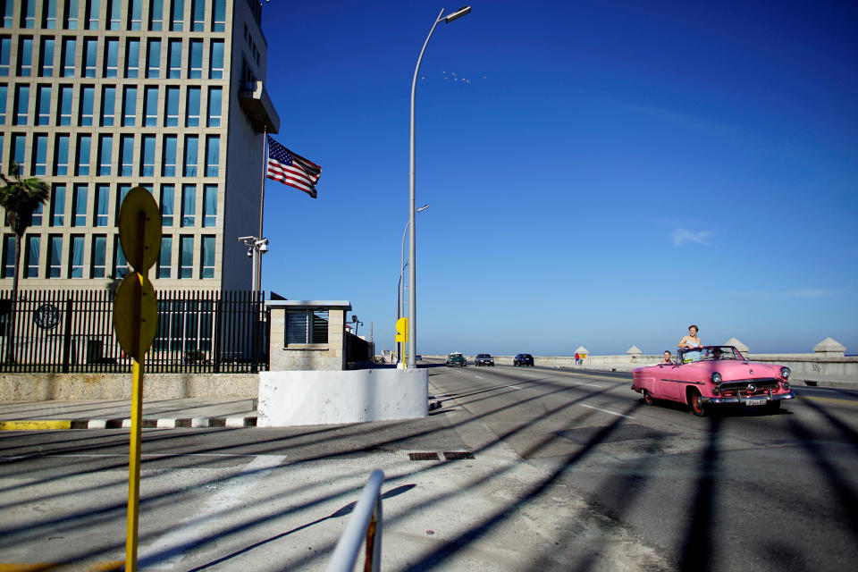 Image: FILE PHOTO: Tourists in a vintage car pass by the U.S. Embassy in Havana (Alexandre Meneghini / Reuters)