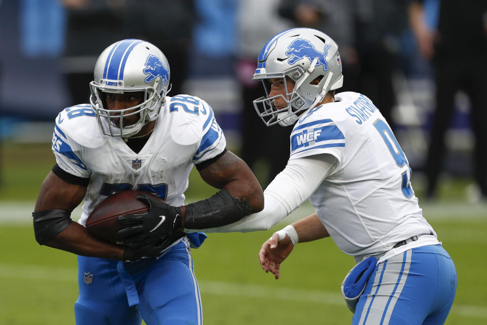 Detroit Lions quarterback Matthew Stafford hands off to the running back Adrian Peterson during the first half of an NFL football game Sunday, Dec. 20, 2020, in Nashville, N.C. (AP Photo/Wade Payne)