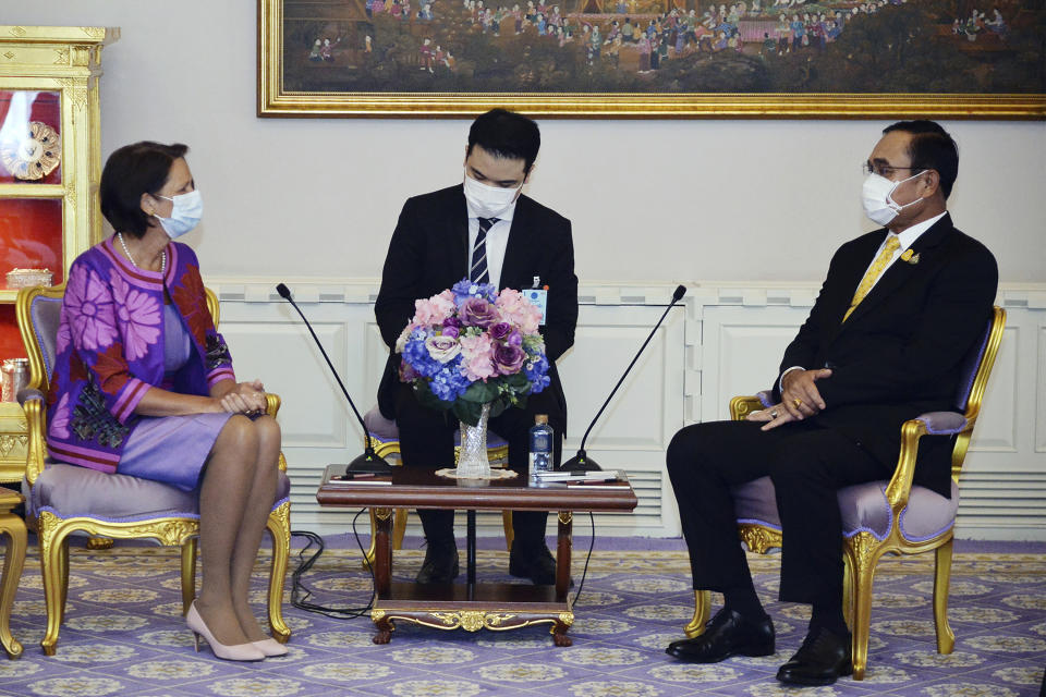 In this photo released by Government Spokesman Office, United Nations Special Envoy to Myanmar Christine Schraner Burgener, left, talks with Thailand's Prime Minister Prayuth Chan-ocha, right, during a meeting at Government House in Bangkok, Thailand, Friday, May 14, 2021. (Government Spokesman Office via AP)