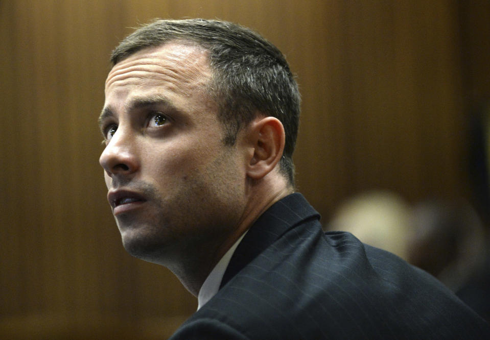 Oscar Pistorius sits in the dock on the second day of his trial at the high court in Pretoria, South Africa, Tuesday, March 4, 2014. Pistorius is charged with murder for the shooting death of his girlfriend, Reeva Steenkamp, on Valentines Day in 2013. (AP Photo/Antoine de Ras, Pool)
