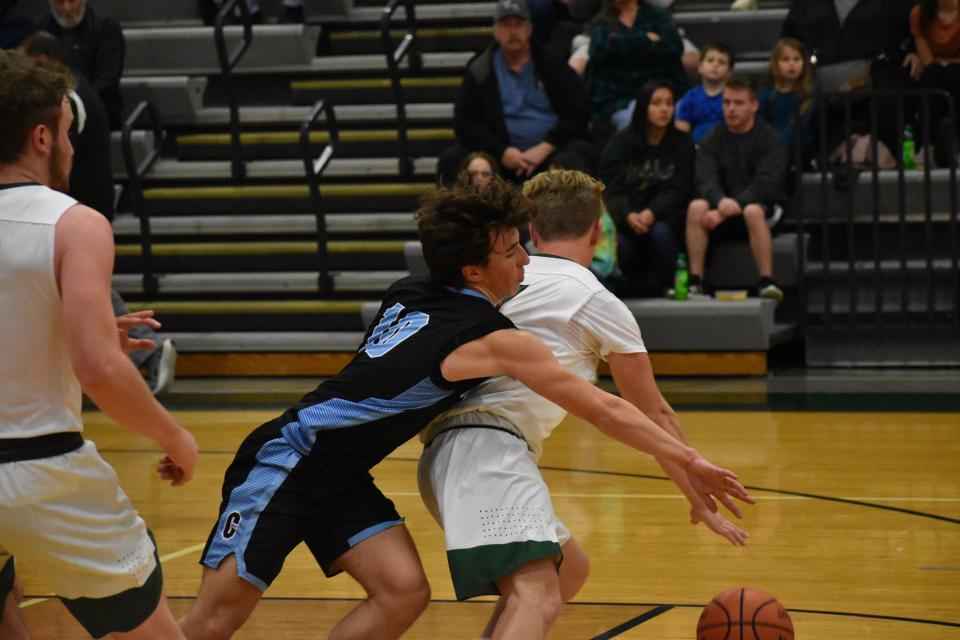 Cascade defender Nick Parsons tries to swipe the ball away from Monrovia's Todd Camic during their game on Dec. 3, 2021.