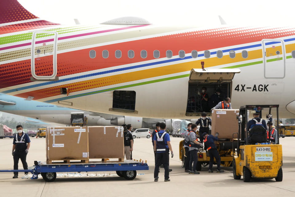 A batch of the Pfizer COVID-19 vaccines sent by Israel is unloaded at the Incheon International Airport in Incheon, South Korea, Wednesday, July 7, 2021. South Korea on Wednesday received 700,000 Pfizer shots from Israel in exchange for a future shipment of vaccines to Israel from September to November, when officials hope South Korea's shortage will have eased. (AP Photo/Ahn Young-joon)