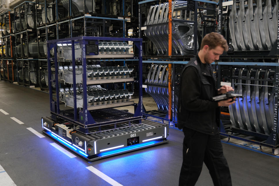 WOLFSBURG, GERMANY - MARCH 01: A technician uses an app to control a Tünkers FTF robotic platform that is transporting stamped car parts at the Volkswagen factory on March 01, 2019 in Wolfsburg, Germany. Volkswagen is scheduled to hold its annual press conference to announce financial results for last year on March 12.(Photo by Sean Gallup/Getty Images)