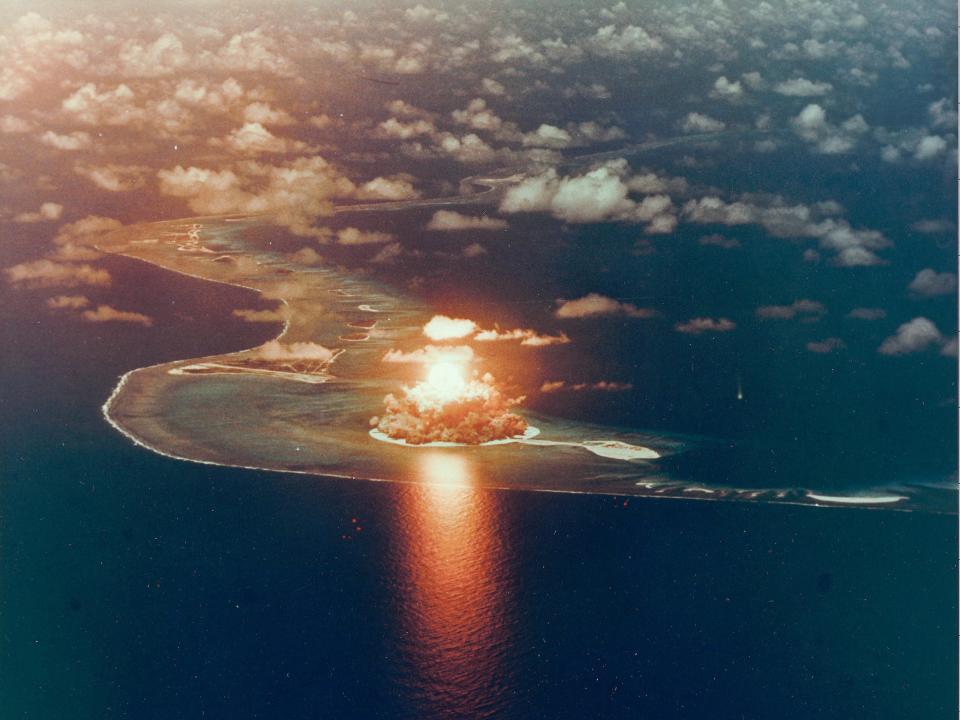 An aerial photo of an explosion on Enewetak Atoll island.