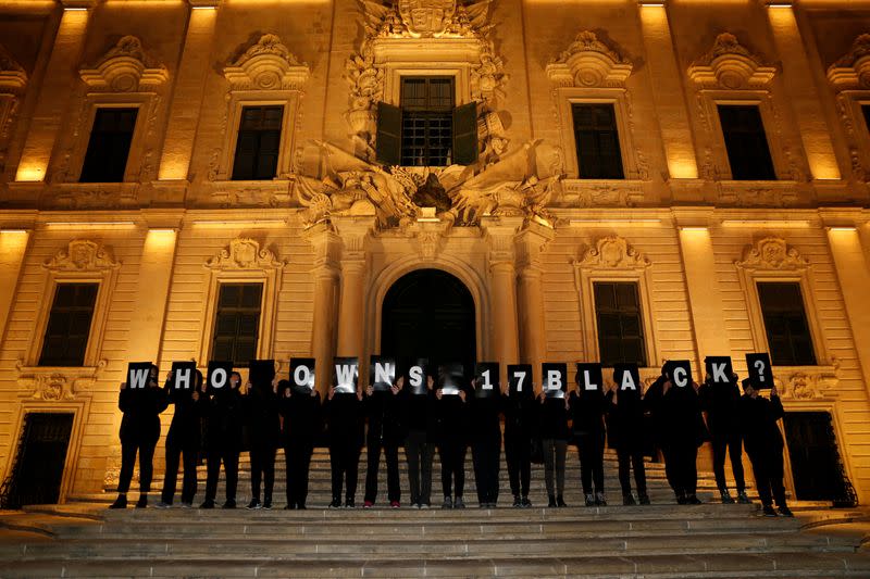 FILE PHOTO: Activists from Occupy Justice Malta hold up placards reading "Who Owns 17 Black?" in reference to revelations by the Daphne Project outside the office of Prime Minister Joseph Muscat at Auberge de Castille in Valletta