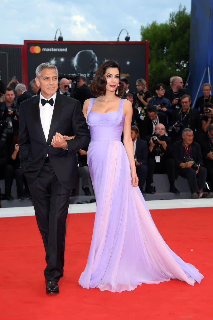 <p>For her first public appearance <a href="https://www.townandcountrymag.com/society/tradition/a10270315/george-amal-clooney-twins-photos/" rel="nofollow noopener" target="_blank" data-ylk="slk:after giving birth to twins;elm:context_link;itc:0;sec:content-canvas" class="link ">after giving birth to twins</a>, Amal Clooney appeared as radiant as ever. The new mom wore a violet Atelier Versace gown, Aquazzura shoes, and finished the outfit with coral-and-lilac Lorraine Schwartz earrings.</p>