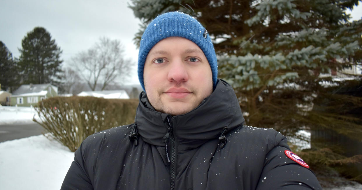 Ed Hornick, who suffers from long COVID, looks into the camera as he stands outside in the snow.