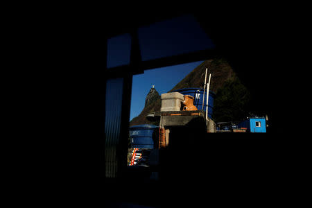 Christ the Redeemer statue is seen through a window of Scene hostel in Santa Marta favela, in Rio de Janeiro, Brazil, April 24, 2016. REUTERS/Pilar Olivares