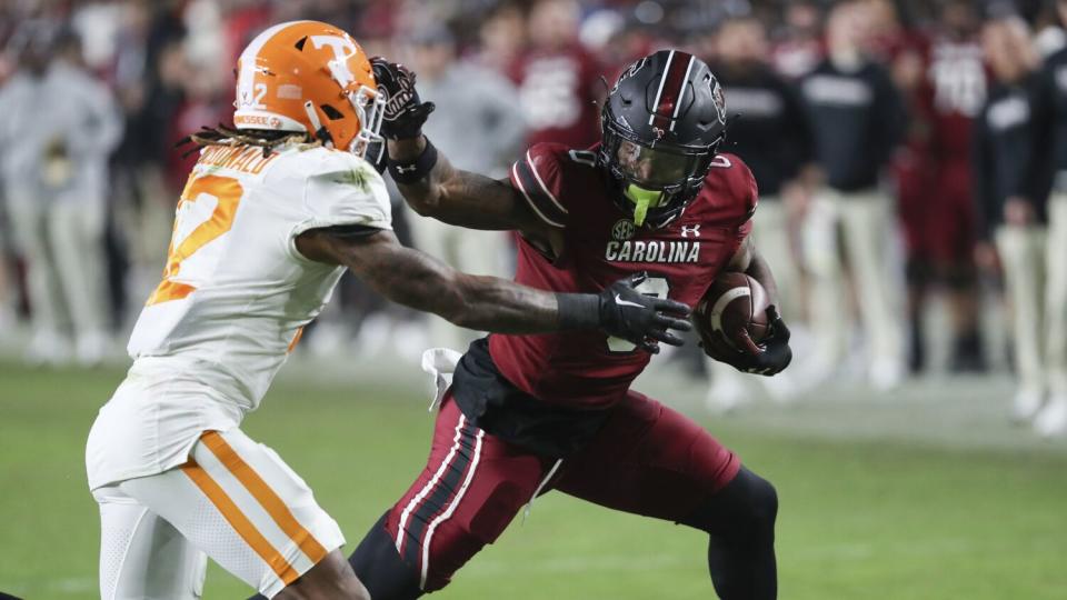 South Carolina tight end Jaheim Bell stiff arms Tennessee defensive back Tamarion McDonald.