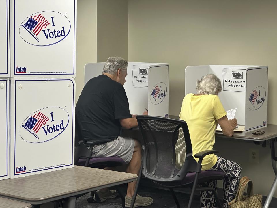 Voters cast their ballots on the first day of early voting, Friday, Sept. 20, 2024 in Alexandria, Va. (AP Photo/Nathan Ellgren)