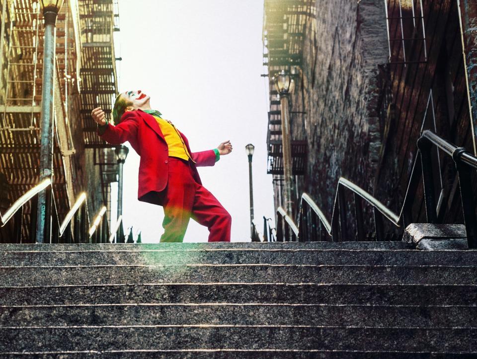 The Joker dances atop some stairs