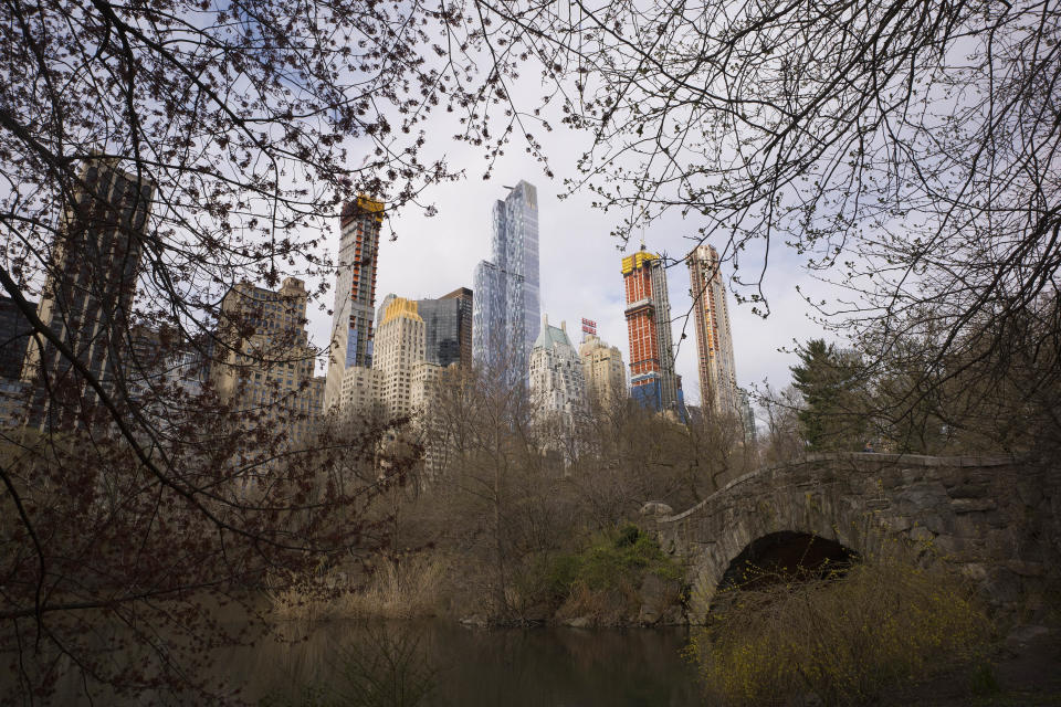 FILE - New apartment buildings are under construction overlooking Central Park and Gapstow Bridge on April 17, 2018, in New York. Supporters of taxes on the very rich contend that people are emerging from the COVID-19 pandemic with a bigger appetite for what they’re calling “tax justice.” Bills announced Thursday, Jan. 19, 2023, in California, New York, Illinois, Hawaii, Maryland, Minnesota, Washington and Connecticut vary in their approaches to hiking taxes, but all revolve around the idea that the richest Americans need to pay more. (AP Photo/Mark Lennihan, File)