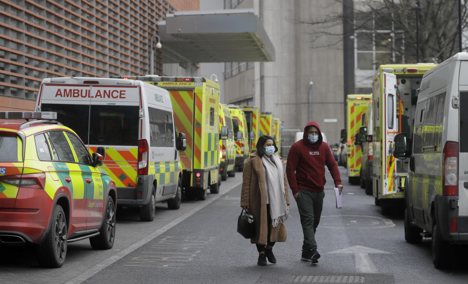 Ambulances are parked outside the Royal London Hospital in London, Monday, Jan. 11, 2021 during England's third national lockdown to curb the spread of coronavirus. The government has imposed a national lockdown while allowing schools to open, with freedom to exercise and shop for food and essential items.(AP Photo/Kirsty Wigglesworth)