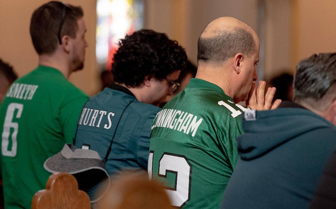 Philadelphia Eagles fans pray during mass at St. Mary’s Basilica on Sunday, Feb. 12, 2023, in Phoenix, Ariz. The Eagles will play the Kansas City Chiefs later on Sunday in Super Bowl LVII.
