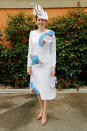 A racegoer wearing a while, embellished dress and matching hat. <em>[Photo: Getty]</em>