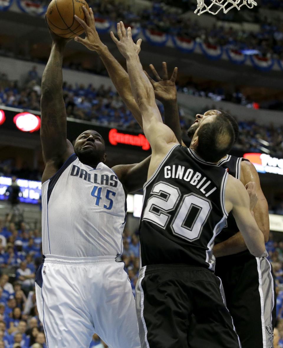 Dallas Mavericks' DeJuan Blair (45) goes up to shoot while contested by San Antonio Spurs' Manu Ginobili (20), of Argentina, and Tim Duncan in the first half of Game 6 of an NBA basketball first-round playoff series on Friday, May 2, 2014, in Dallas. (AP Photo/Tony Gutierrez)