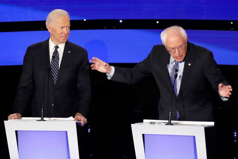 Democratic 2020 U.S. presidential candidates former Vice President Joe Biden listens to Senator Bernie Sanders at the seventh Democratic 2020 presidential debate at Drake University in Des Moines