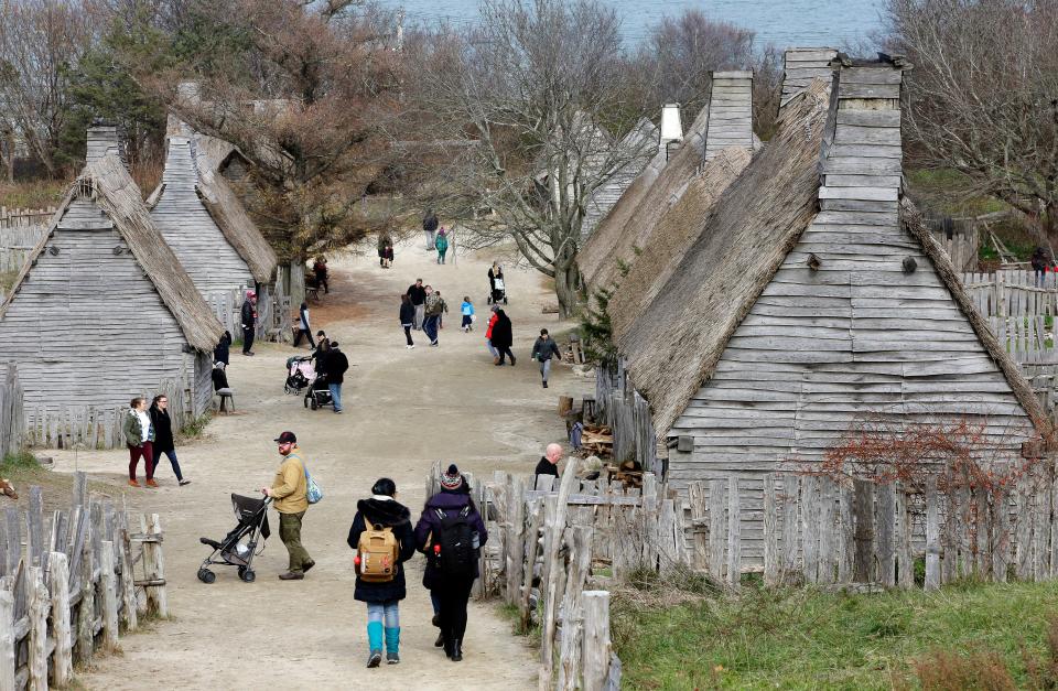 Visitors walk through the 17th-Century English Village exhibit at the Plimoth Patuxet Museums on Nov. 18, 2018, in Plymouth.