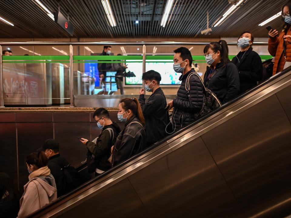 chinese people on escalators