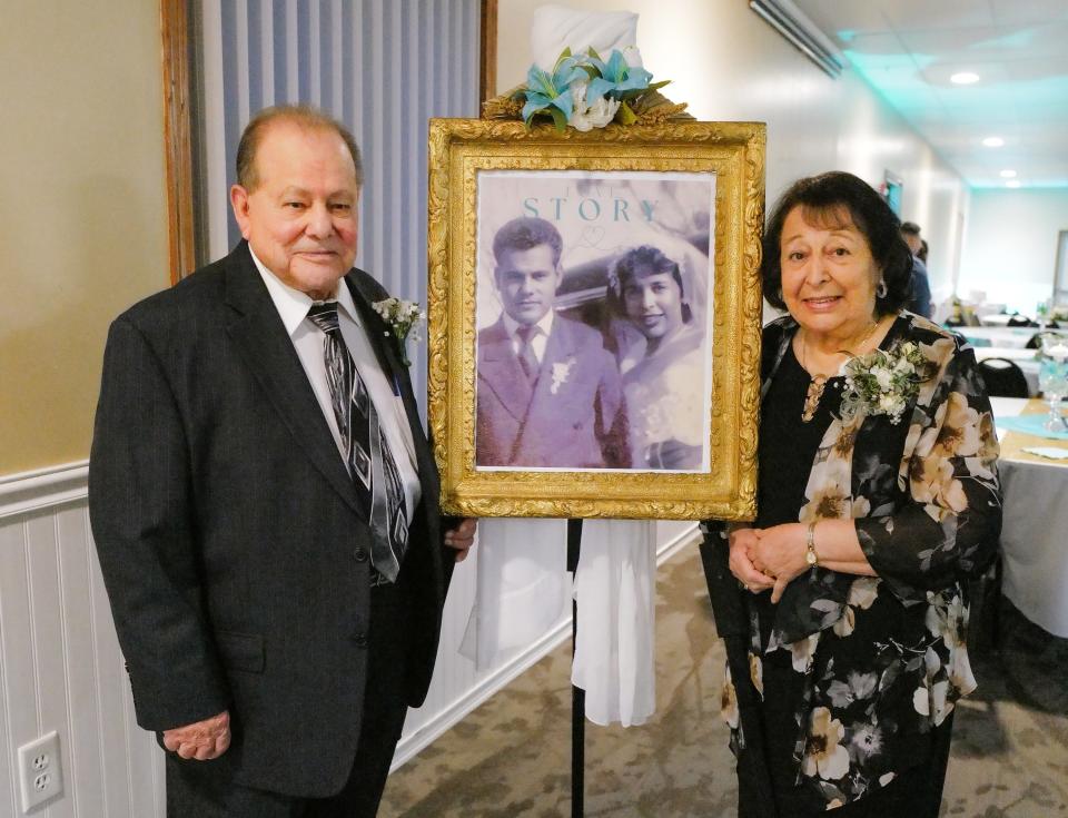 Manuel and Mary Delgado have been married for 70 years and stand by a photo from their wedding day at a celebration party in Mason Saturday, Jan. 6, 2024.