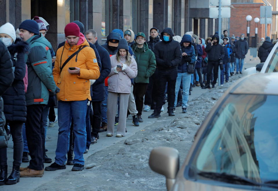 People stand in line to use an ATM money machine in Saint Petersburg in Russia on February 27.