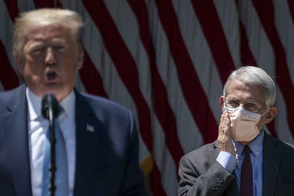 Dr. Anthony Fauci (R), director of the National Institute of Allergy and Infectious Diseases, looks on as U.S. President Donald Trump delivers remarks about coronavirus vaccine development in the Rose Garden of the White House on May 15, 2020 in Washington, DC.