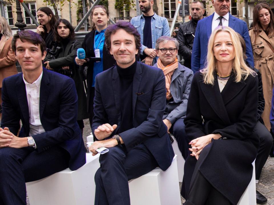 Delphine Arnault with her brothers and Bernard Arnault sit front row at a fashion show