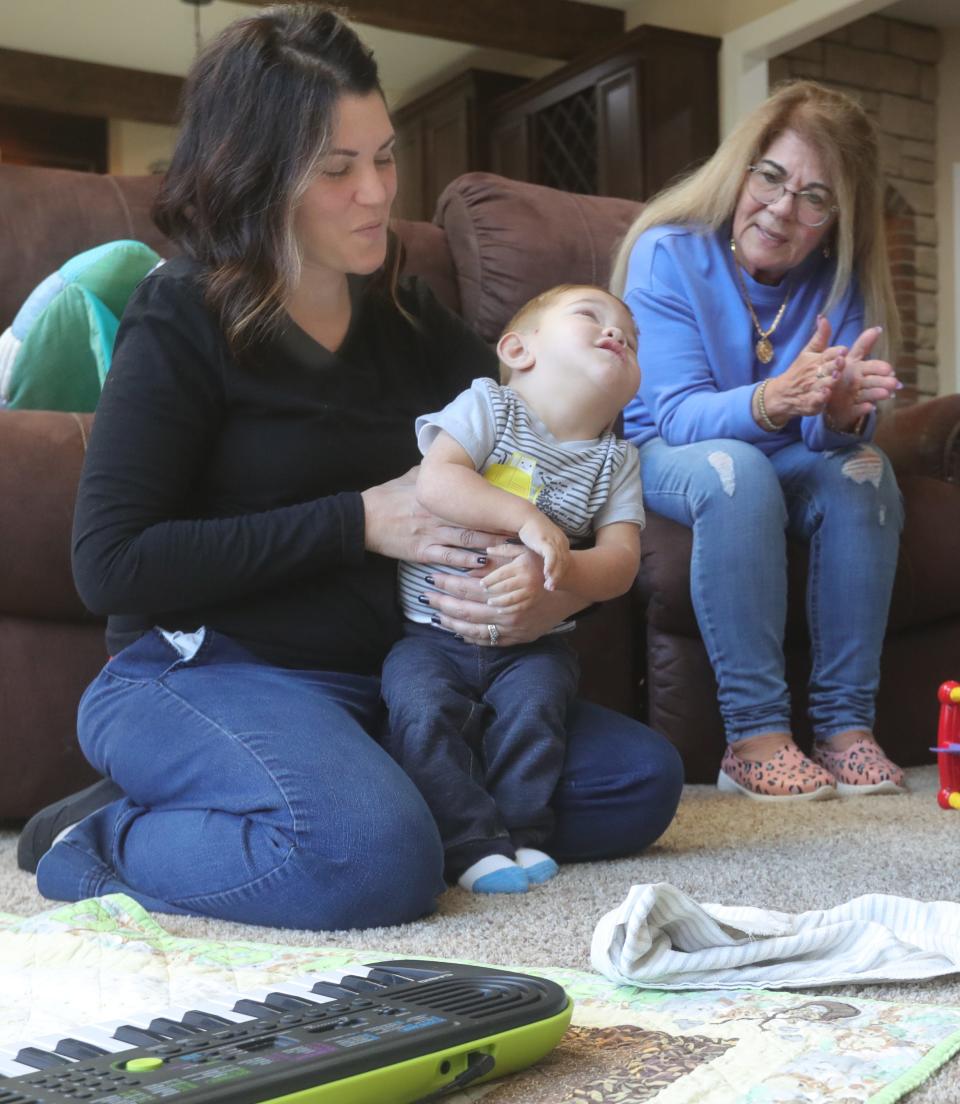 Carlla Detwiler with her son David and her mother, Micaela Vinitti, in the Detwilers' Massillon home.