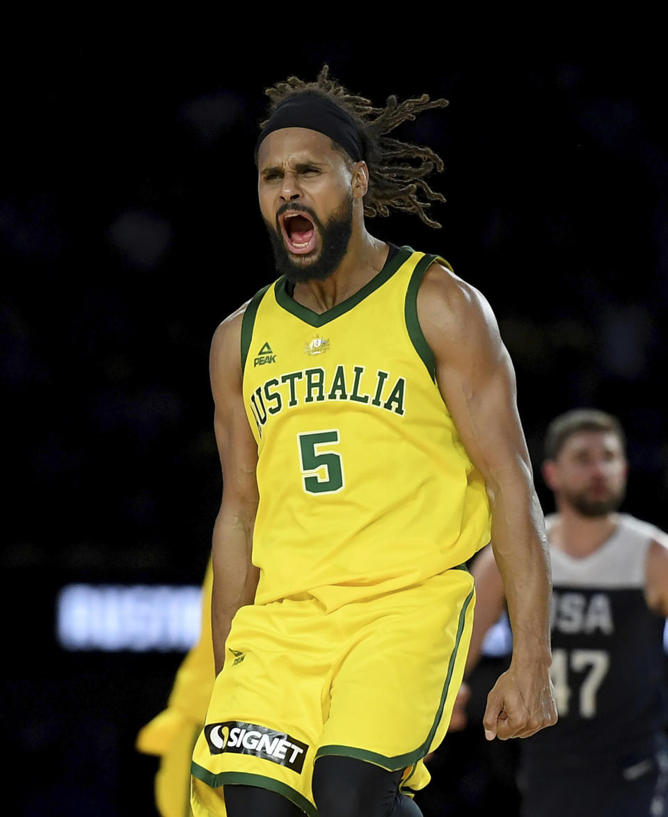 Australia's Patty Mills celebrates after shooting a 3-pointer during their exhibition basketball game against the U.S in Melbourne, Saturday, Aug. 24, 2019. (AP Photo/Andy Brownbill)