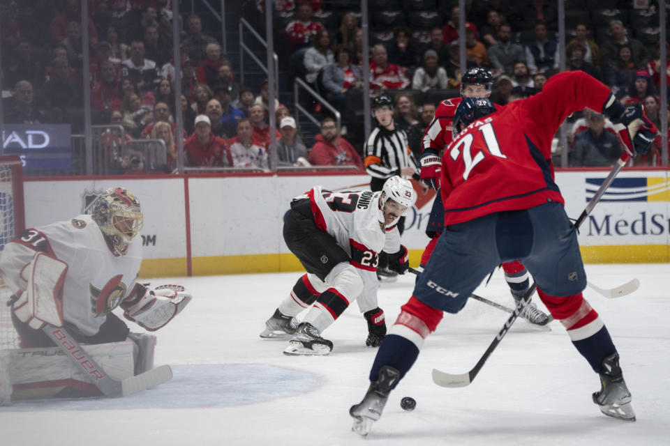 Washington Capitals center Aliaksei Protas (21) hits the puck and scores during the first period of an NHL hockey game agains the Ottawa Senators, Monday, Feb. 26, 2024, in Washington. (AP Photo/Manuel Balce Ceneta)