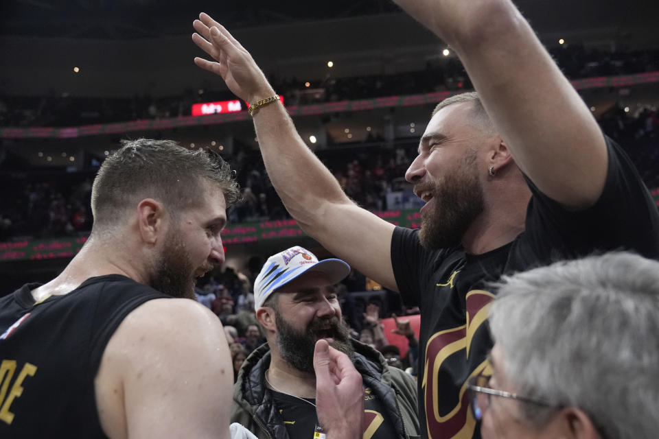 Cleveland Cavaliers forward Dean Wade, left, celebrates with Jason Kelce, center, and Travis Kelce, right, after the Cavaliers defeated the Boston Celtics in an NBA basketball game, Tuesday, March 5, 2024, in Cleveland. (AP Photo/Sue Ogrocki)