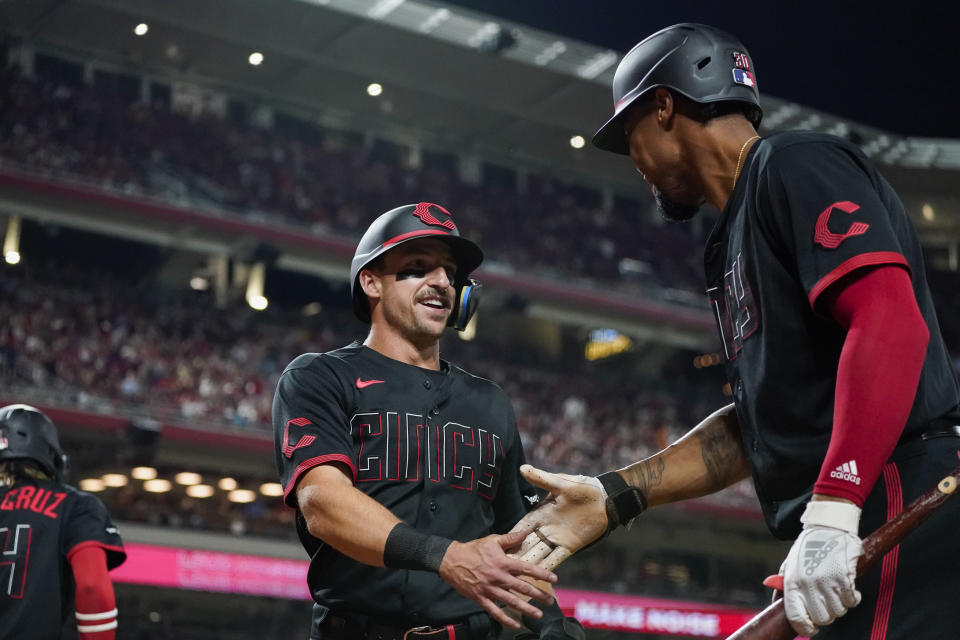 Cincinnati Reds' Spencer Steer, left, celebrates with Will Benson after scoring against the Pittsburgh Pirates during the fifth inning of a baseball game Friday, Sept. 22, 2023, in Cincinnati. (AP Photo/Joshua A. Bickel)