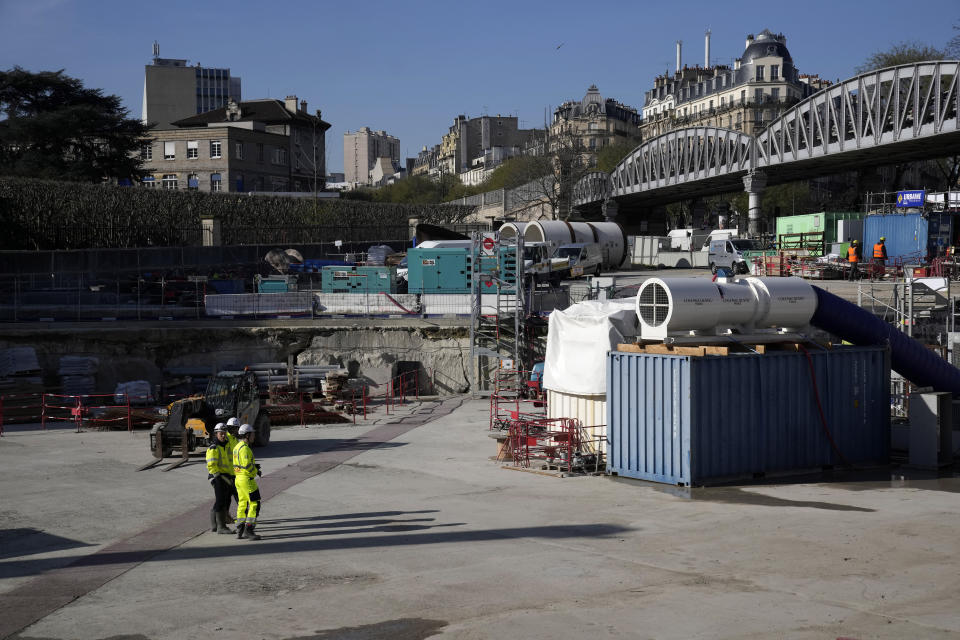 Workers stand at water storage tank construction site in Paris, Wednesday, April 5, 2023. A costly and complex clean-up is resuscitating the River Seine just in time for it to play a starring role in the 2024 Paris Olympics. The city and its region are rushing to make the Seine's murky waters swimmable, so it can genuinely live up to its billing as the world’s most romantic river. (AP Photo/Christophe Ena)