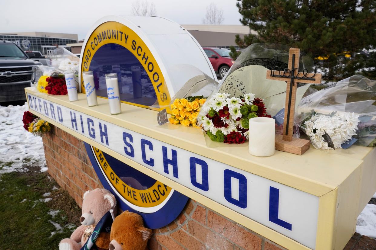 Memorial items are shown on the sign of Oxford High School in Oxford, Mich., Wednesday, Dec. 1, 2021. 