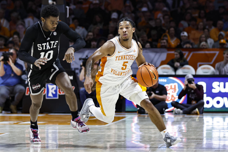 Tennessee guard Zakai Zeigler (5) drives past Mississippi State guard Dashawn Davis (10) during the second half of an NCAA college basketball game Tuesday, Jan. 3, 2023, in Knoxville, Tenn. (AP Photo/Wade Payne)